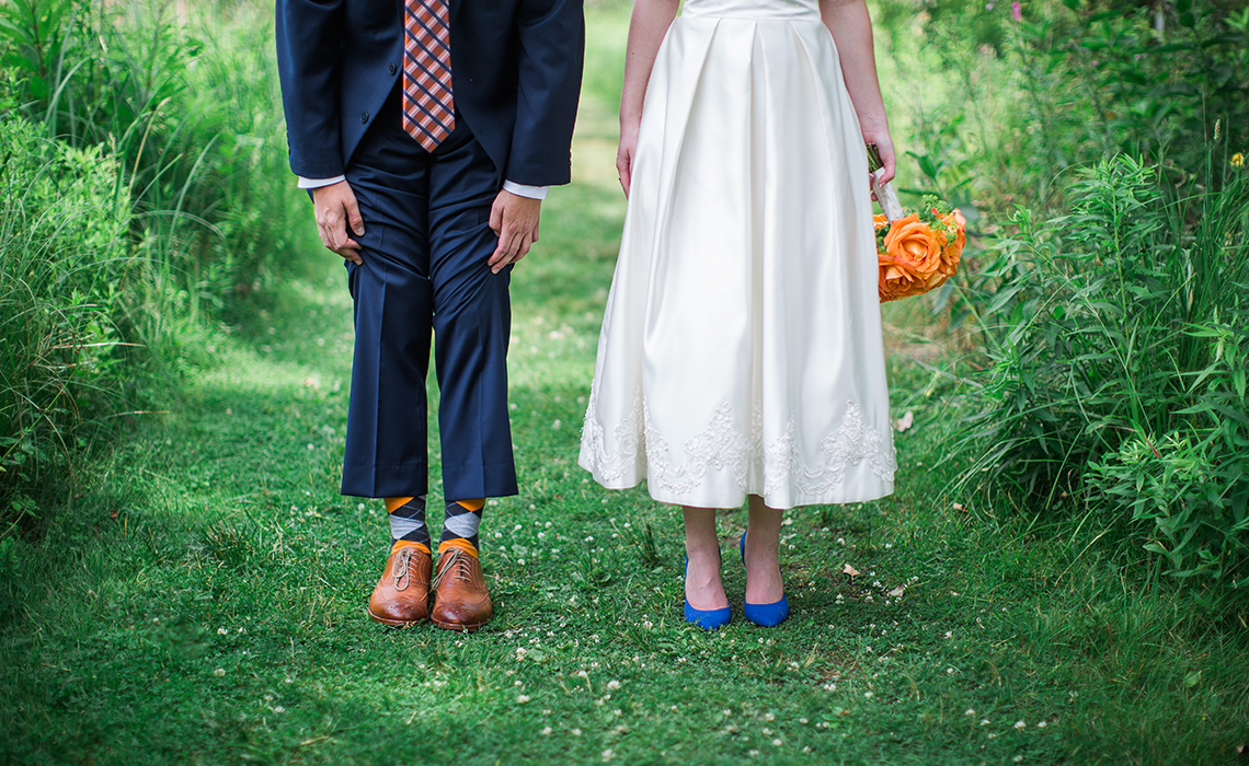Ashley & Josh show their decorative socks and beautiful bridal shoes in Ann Arbor