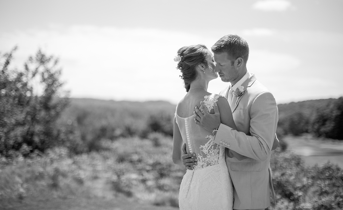 The bride and groom share a romantic moment after their first look on the green at A Ga Ming Golf Resort in Northern Michigan.