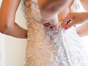 As Maureen and Dave prepare to get married, Maureens mother buttons the back of her bridal dress at the Greenmeade Historical Village in Farmington Hills, Michigan.