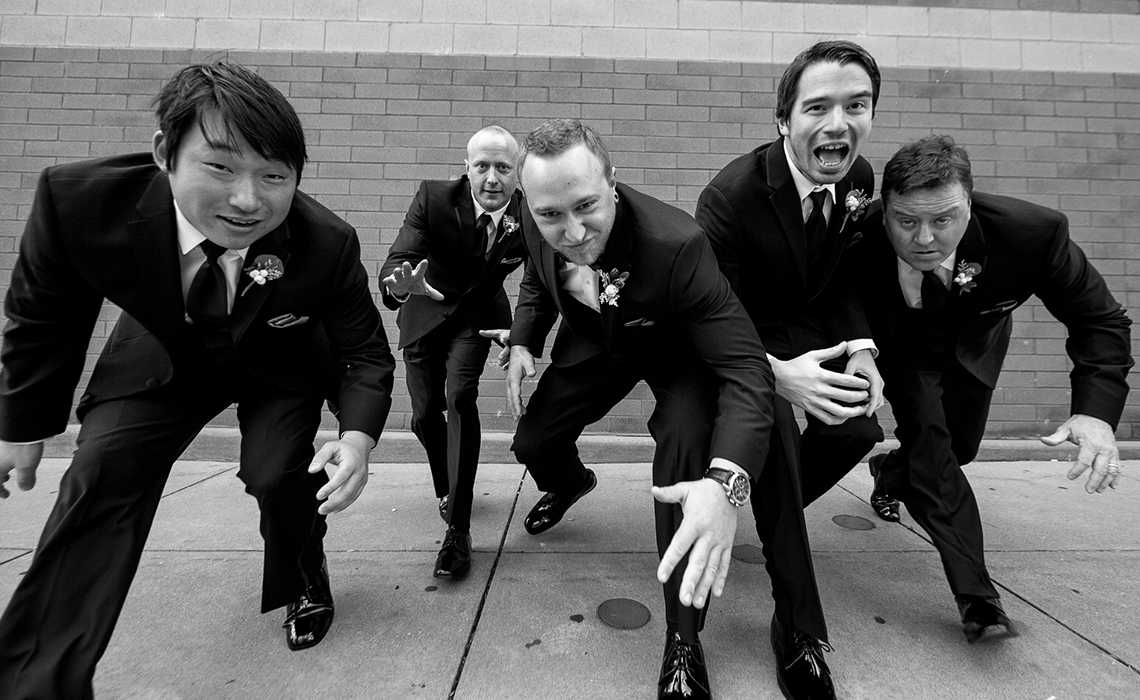 Aaron and his groomsmen have fun during their wedding day photography session.