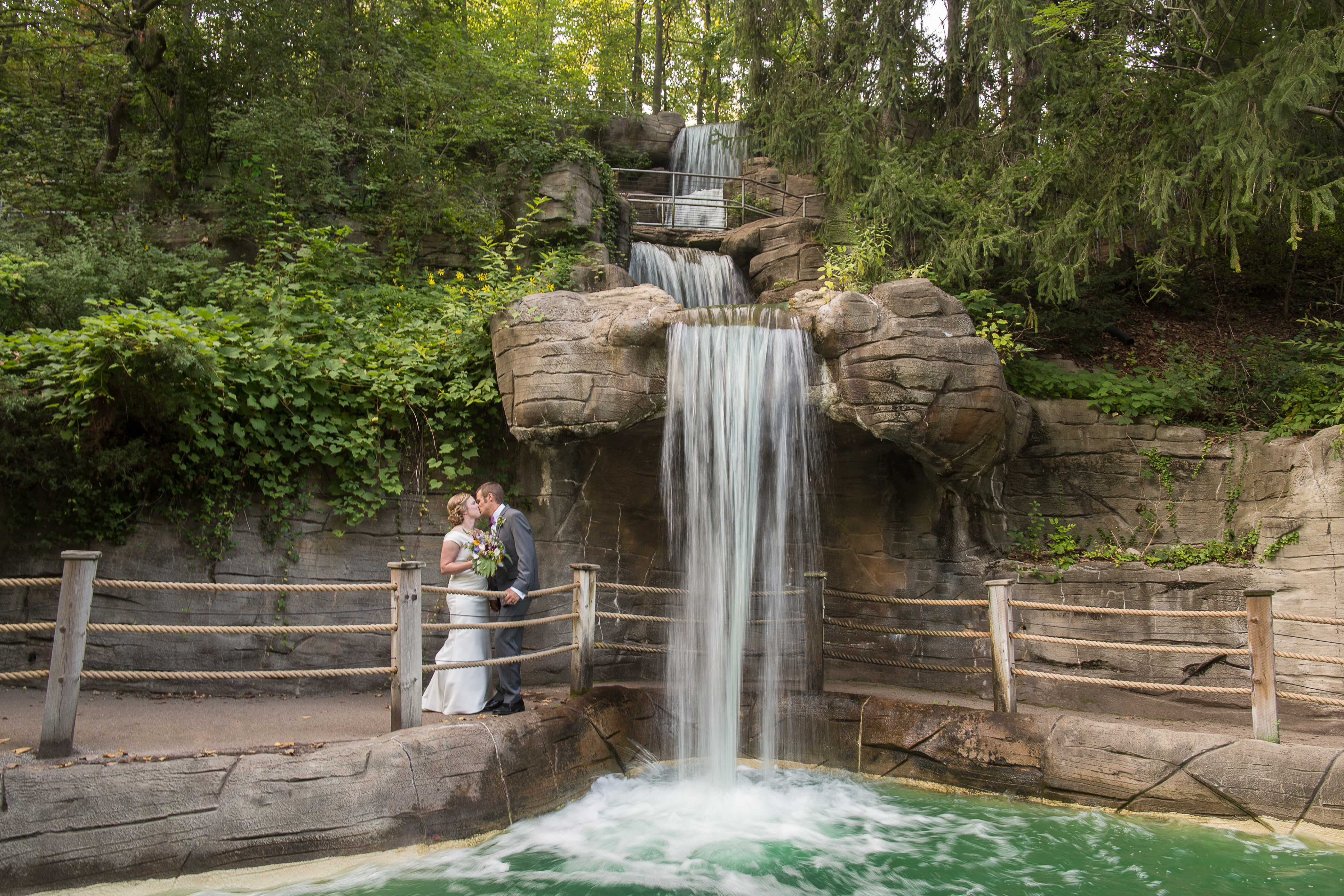john_ball_zoo_wedding_photographer Elise & Chris stand under a waterfall on their wedding day