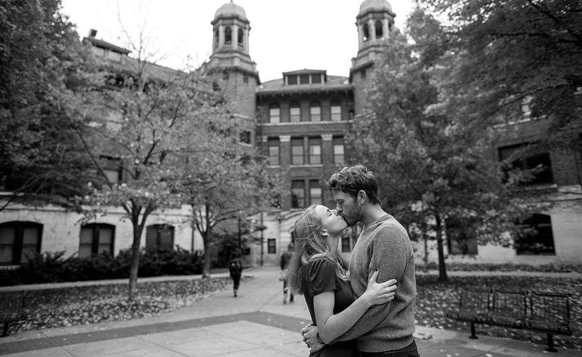 Nicole & Nicholas kiss blissfully unaware of the hustle and bustle around them on the University of Michigan College campus in Ann Arbor, Michigan